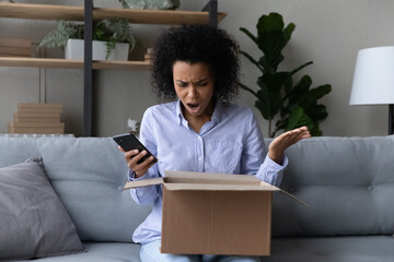 Unhappy mixed race female buyer feel frustrated disappointed with bad quality order unpack parcel...
