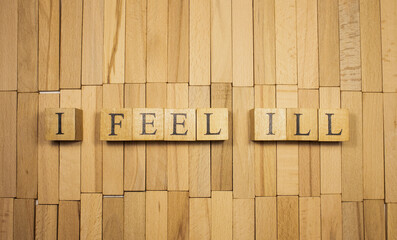 The word I fell ill was created from wooden cubes. Health and life. Close up.