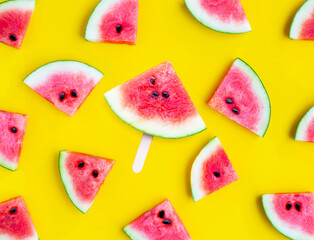 Slices of watermelon on yellow background.