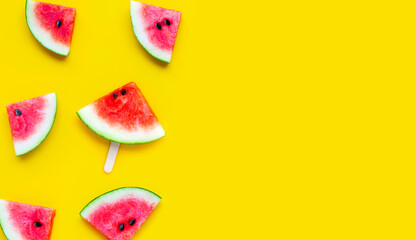 Slices of watermelon on yellow background.
