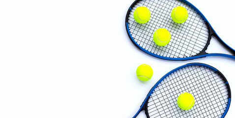 Tennis rackets with balls on white.