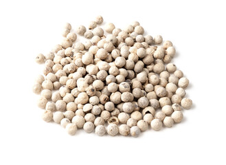 handful of white pepper peppercorns on white