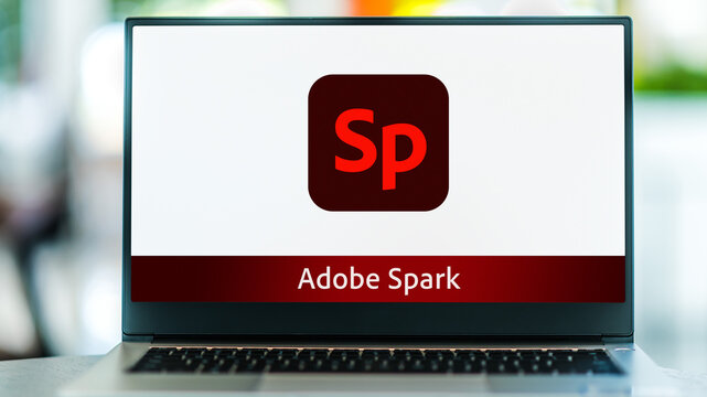 Laptop computer displaying logo of Adobe Spark