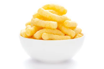Foto op Aluminium Close up of Cheese Potato Puff Snacks sticks, Popular Ready to eat crunchy and puffed snacks sticks  cheesy salty pale-yellow color over white background © Prashant ZI