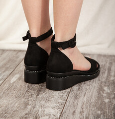 Female feet shod in black shoes
