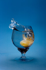 Cocktail with gin-tonic, orange slice and splash