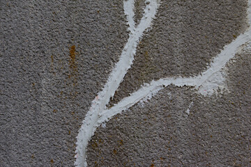 Concrete wall with crack repaired with white concrete patching putty