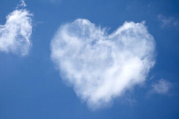 Naklejka na ściany i meble Heart shaped cloud on bright blue sky and white clouds, Symbol of pure love. concept of romantic love.