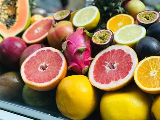 Mix Of Different Fresh Exotic Fruits: grapefruit, dragon fruit, passion fruit, papaya, orange and lemon