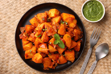 Masala Idli or Masala idly coconut chutney green chutney popular breakfast of Kerala Tamil Nadu South India and Sri Lanka. Healthy steamed rice cakes steaming fermented batter of black lentils , rice.