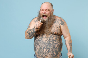 Young expressive happy fat pudge obese chubby overweight blue-eyed bearded man 30s has big belly...