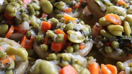 Healthy food Artichoke on the white plate. Close-up Artichoke food with beans, peas, onions and carrots. Delicious healthy vegan food with olive oil.