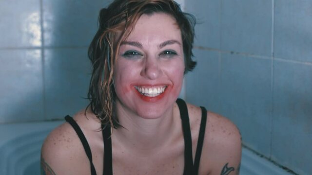 mental alienation - girl with psychic problems laughs hysterically at camera