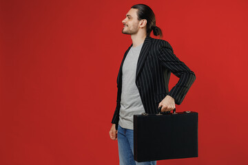 Side view young successful businessman latin man 20s with ponytail wearing black striped jacket...