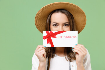 Traveler tourist woman in casual clothes hat camera cover mouth with gift voucher flyer mock up...
