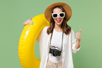 Traveler tourist fun woman in casual clothes hat holding inflatable swimming ring show ok okay...