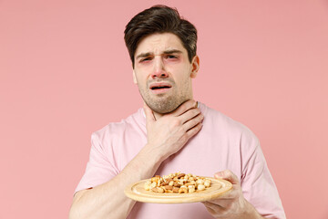 Sick unhealthy ill allergic man has red swelling watery eyes, runny stuffy sore nose suffer from...