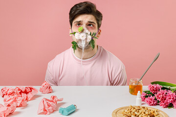 Sick allergic man has red watery eyes oxygen mask difficulty breathing suffer from allergy symptom...