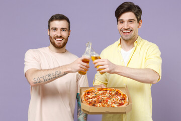 Two young men friends together in casual t-shirt tattoo translate fun eat italian pizza in...