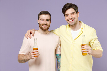 Two cool cheerful young men friends together 20s wearing casual t-shirt tattoo translate fun hug...