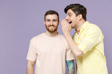 Two smiling young men friends together wear casual t-shirt tattoo translate fun whispering gossip...