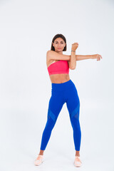 Fit tanned sporty woman with abs, fitness curves, wearing top and blue leggings on white background