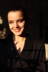 Beautiful young happy girl in black jacket close up studio portrait,