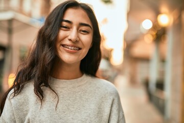 Fototapeta premium Young middle east girl smiling happy standing at the city.