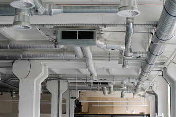 Air condition and hvac system installation under bareskin ceiling before interior finishing. System...