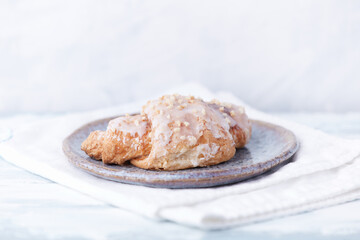 Croissant on bright wooden background. Close up. Copy space.	