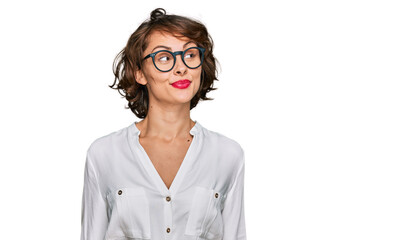 Young hispanic woman wearing business style and glasses smiling looking to the side and staring away thinking.