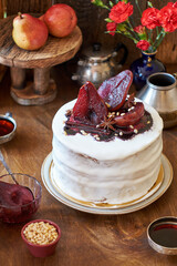 Pear cake. Stewed pear in red wine, pine nuts, star anise, cinnamon stick, wine syrup, cheesecake with gorgonzola. Side view, wooden background.