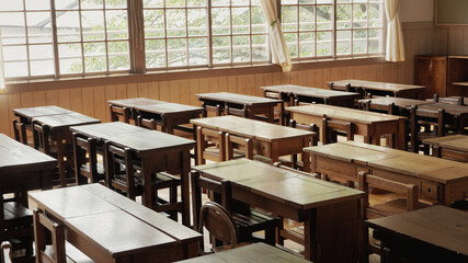 Desks in an empty school classroom.