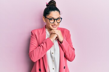 Beautiful middle eastern woman wearing business jacket and glasses laughing nervous and excited...