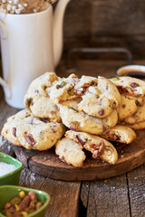 Cookies with caramel, pistachios and chocolate. Wooden background, side view