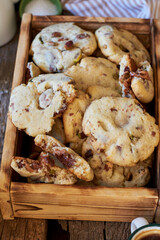Cookies with caramel, pistachios and chocolate. Wooden box, top view