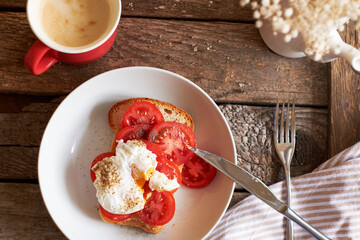 Toast with tomatoes and egg Benedict. Top view