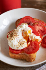 Toast with tomatoes and egg Benedict. Top view