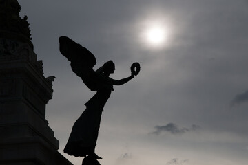 Silhouette of an ancient angel of peace statue of the victor Emmanuel II monument / Vittoriano...