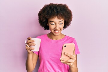 Young hispanic girl using smartphone and drinking a cup of coffee smiling with a happy and cool smile on face. showing teeth.