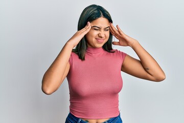 Young latin woman wearing casual clothes with hand on head, headache because stress. suffering migraine.