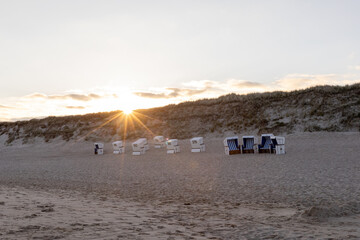 Sunset on the beach of Westerland on Sylt. deserted beach chairs in the golden hour. 