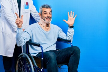 Handsome middle age man with grey hair on wheelchair wearing cervical collar showing and pointing...