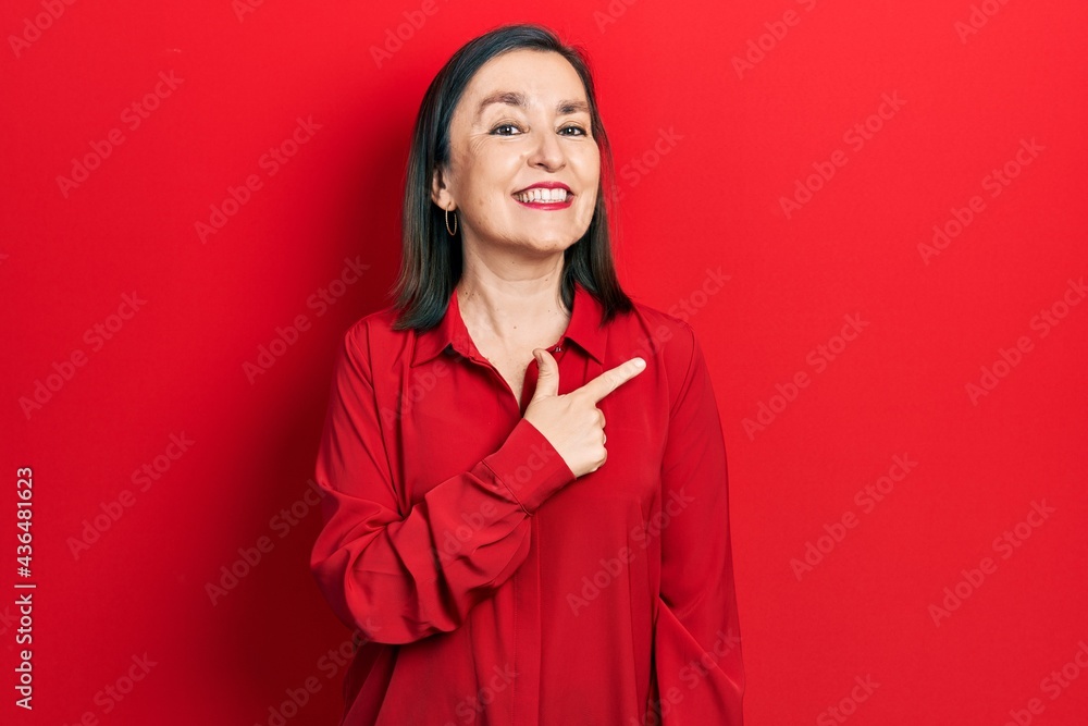 Canvas Prints Middle age hispanic woman wearing casual clothes cheerful with a smile on face pointing with hand and finger up to the side with happy and natural expression