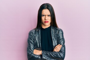 Young hispanic girl wearing party jacket skeptic and nervous, disapproving expression on face with...
