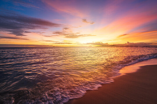 Beautiful sunset over the sea at tranquil tropical beach in summer