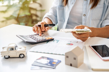 Stressed young woman calculating monthly home expenses, taxes, bank account balance and credit card bills payment, Income is not enough for expenses