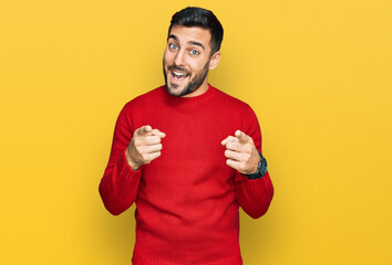 Young hispanic man wearing casual clothes pointing fingers to camera with happy and funny face....