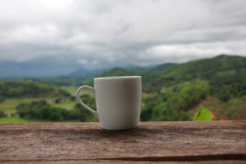 cup of tea on a table with mountains view background