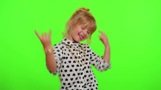 Rock-n-roll gesture. Overjoyed delighted funny stylish blonde kid child showing cool sign by hands shouting yeah with crazy expression, dancing emotionally rejoicing in success. Teenager children girl